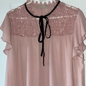Pink blouse with a black ribbon